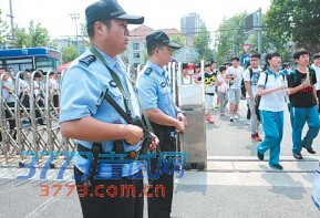 12日,济南商贸学校大门口,济南市历下区公安分局巡警大队一中队的民警持枪在校门口执勤,确保考场考生的