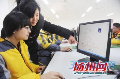 一名学生正在老师的辅导下报名。司新利摄